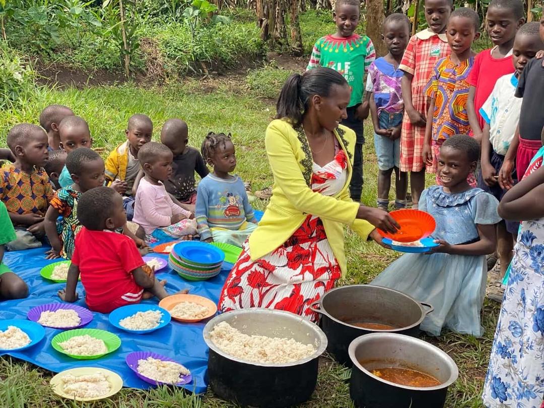 Brenda serving food to children