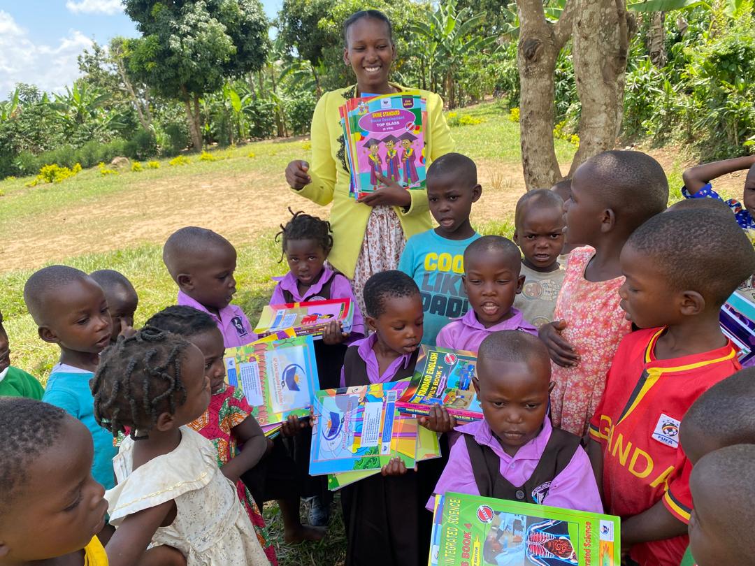Brenda handing out books to a group of children
